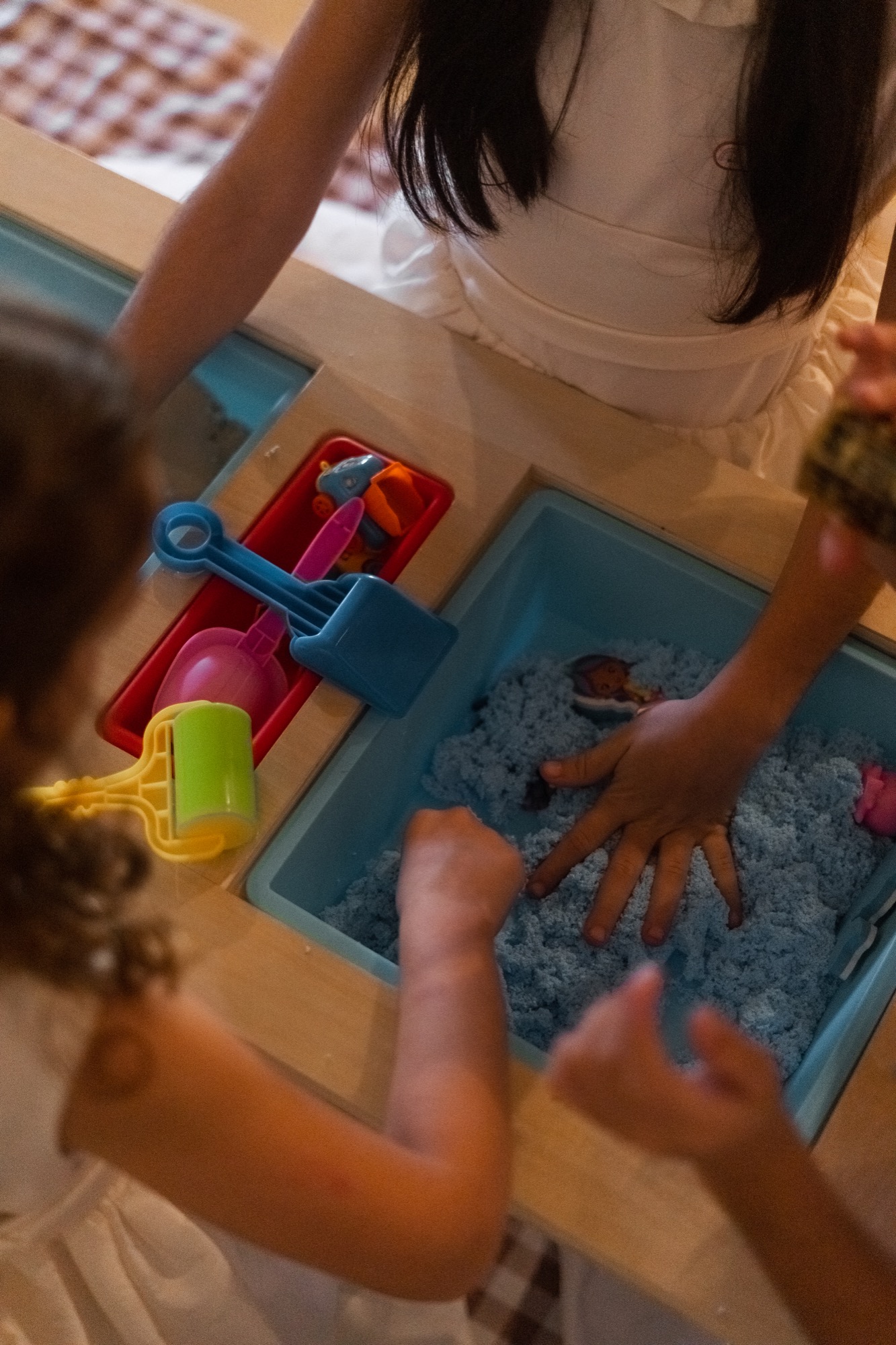 Sensory table with kinetic sand set up for children at a South Florida wedding