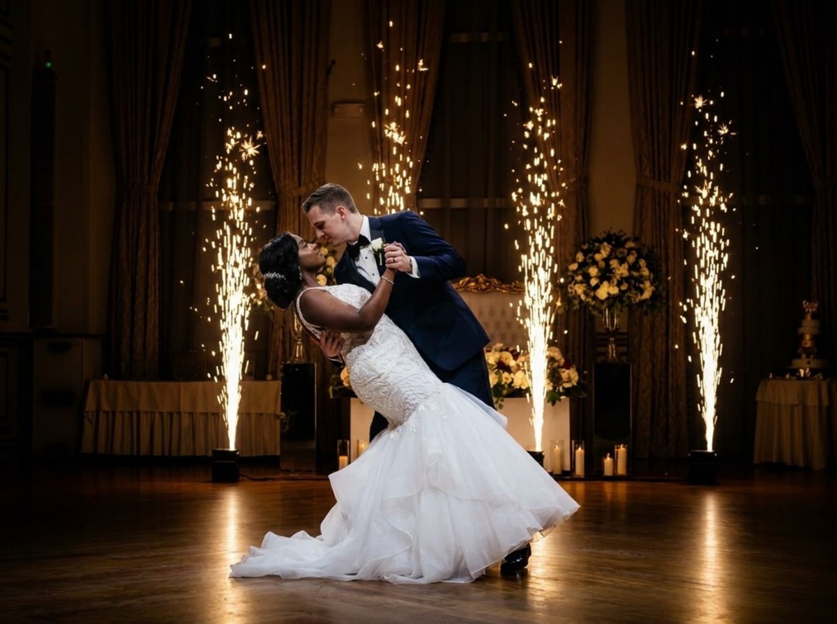 Bride and groom first dance with cold spark fountains in a ballroom