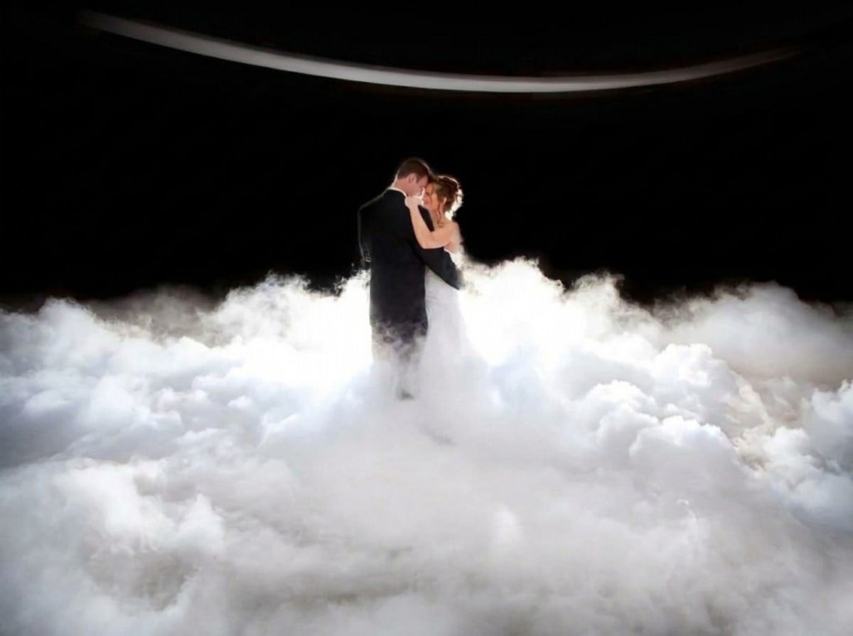 Bride and groom dancing on low-lying dry ice fog cloud at a wedding reception