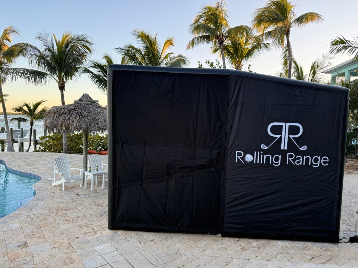 Rolling Range branded simulator enclosure set up poolside at an outdoor venue